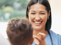 Smiling healthcare professional interacting with a child